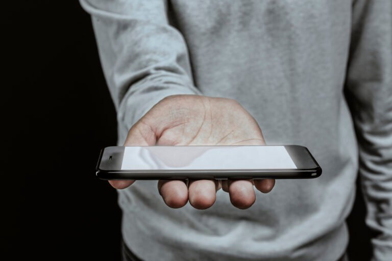 man holding smartphone with white screen